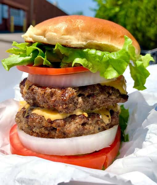 Double cheeseburger with lettuce, tomato and onion