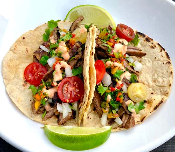 Street tacos topped with onion and cilantro