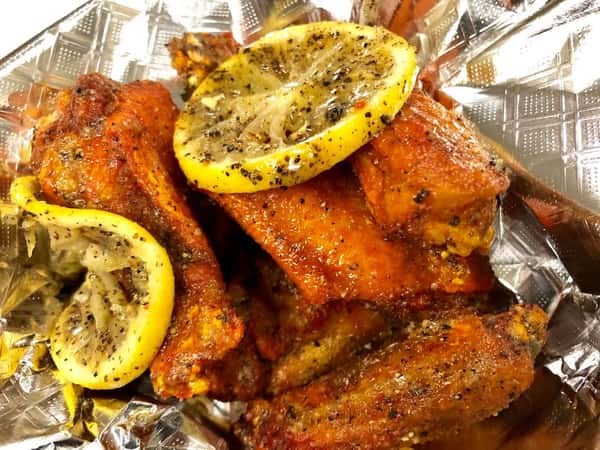 Saucy wings served with dipping sauce